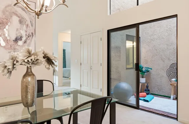 a view of a dining room with furniture and chandelier
