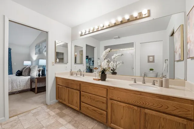 a bedroom with a bed and a painting on the wall