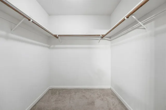 a bedroom with a bed and a desk