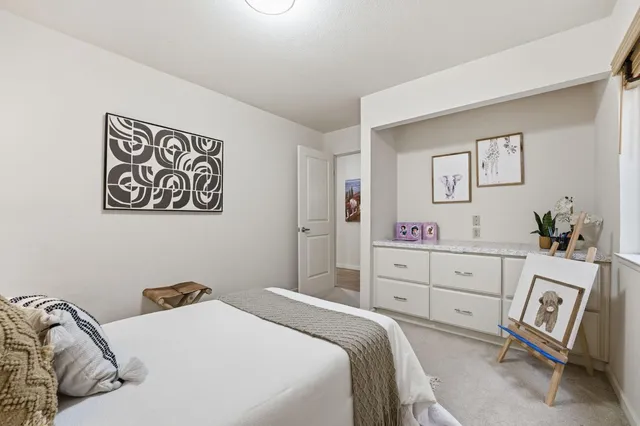 a living room with furniture potted plant and a table