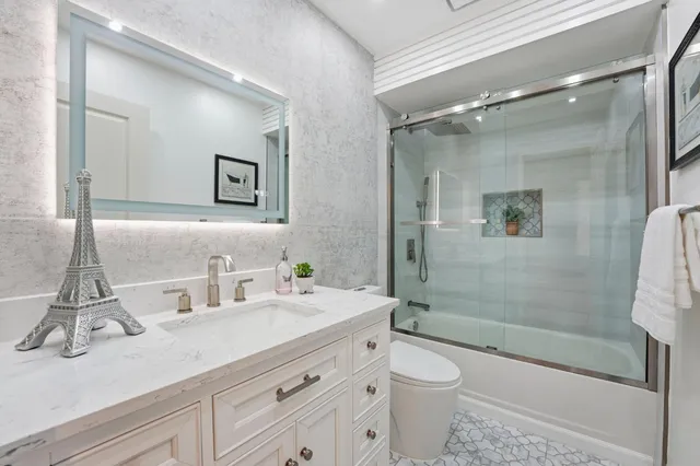 a view of a backyard with table and chairs and a large tree