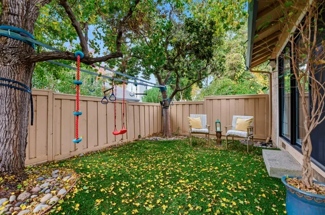 a view of swimming pool with table and chairs