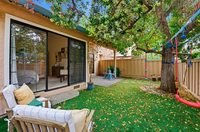 a garden with trees in front of it