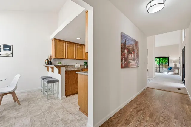 a dining room with furniture a chandelier and kitchen view