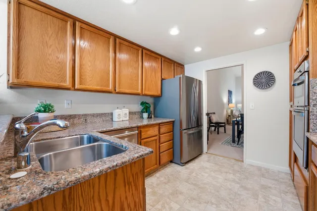 a kitchen with stainless steel appliances granite countertop a stove and a sink