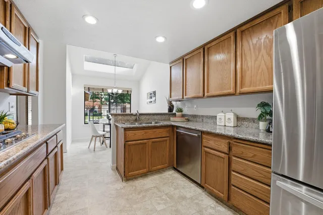 a kitchen with stainless steel appliances granite countertop a stove and a cabinets