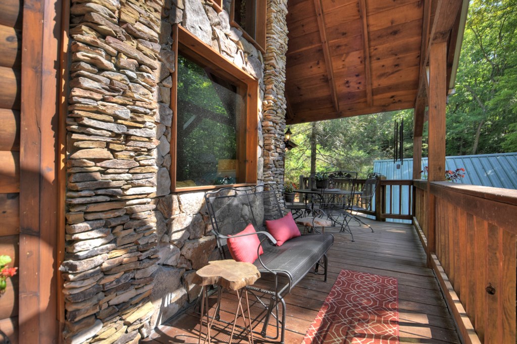 91 Dream Cove Road Cherry Log, GA 30522 - Photo 31 of 83 a view of a patio with a dining table and chairs with wooden floor and fence