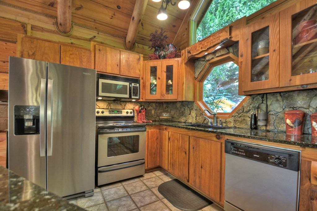 91 Dream Cove Road Cherry Log, GA 30522 - Photo 42 of 83 a kitchen with stainless steel appliances granite countertop a refrigerator a sink a stove and washer