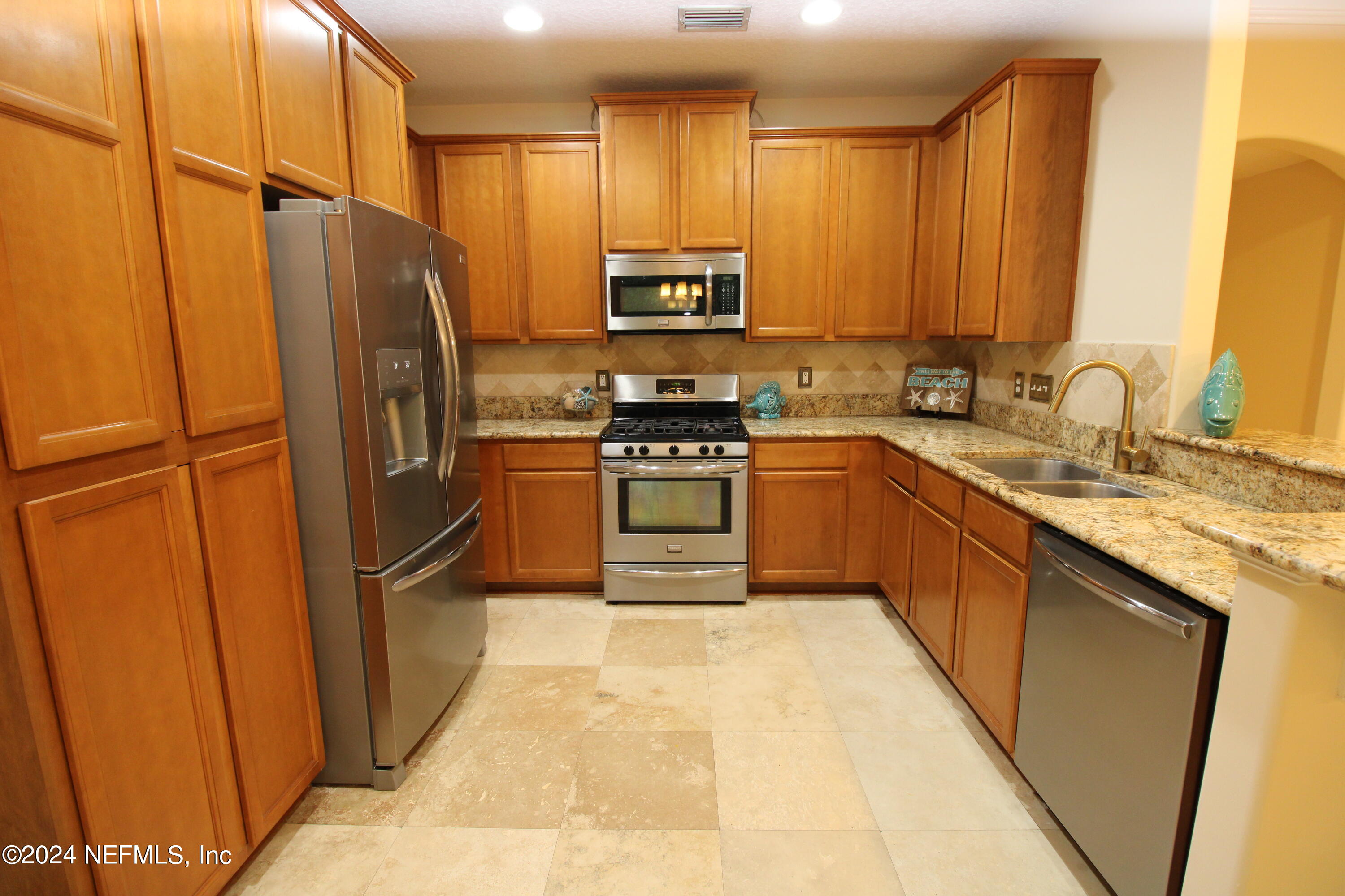 28 Grand Ravine Drive St. Augustine, FL 32086 - Photo 13 of 55 a kitchen with stainless steel appliances granite countertop a refrigerator a sink and a stove