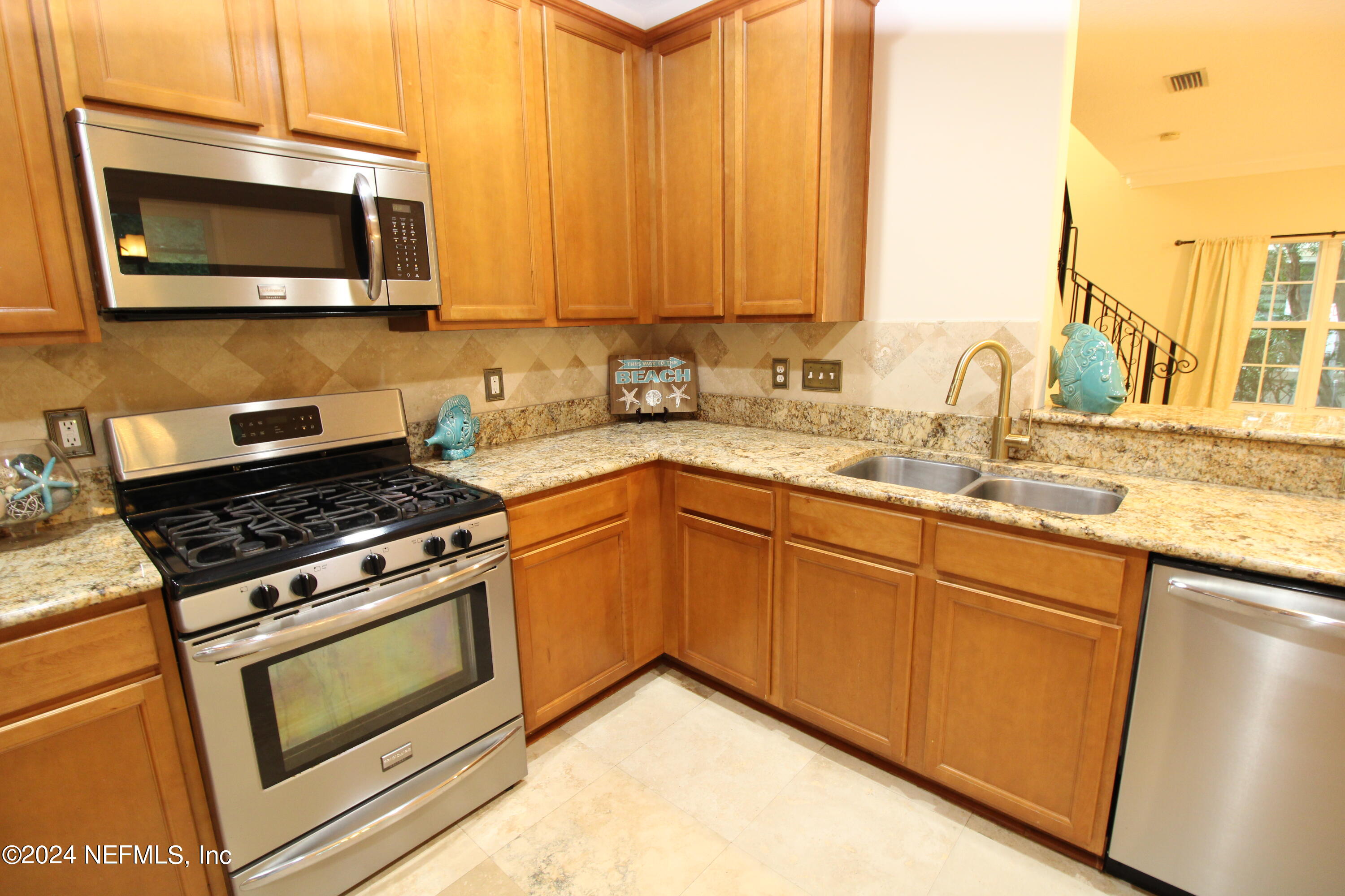 28 Grand Ravine Drive St. Augustine, FL 32086 - Photo 15 of 55 a kitchen with stainless steel appliances granite countertop a stove microwave and sink