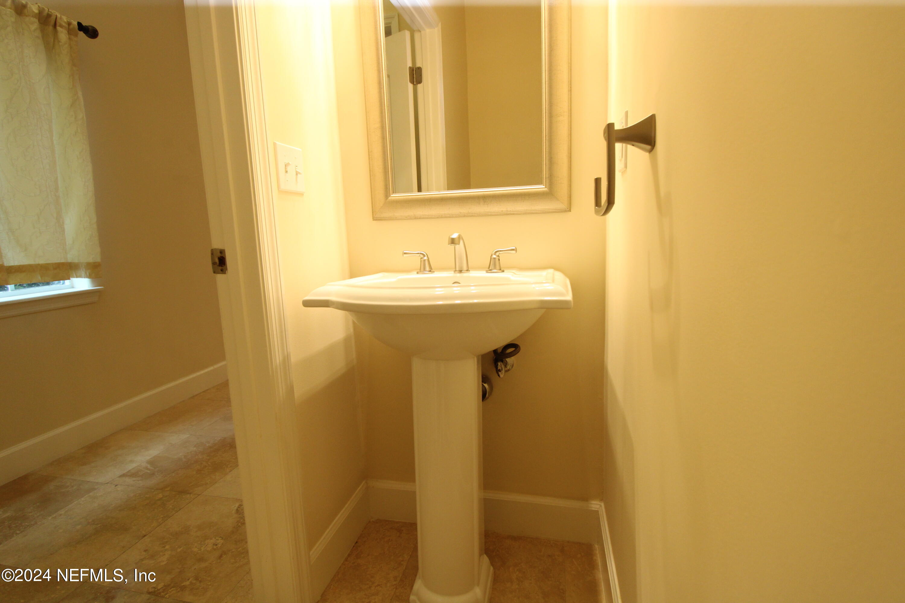 28 Grand Ravine Drive St. Augustine, FL 32086 - Photo 16 of 55 a bathroom with a sink and a mirror