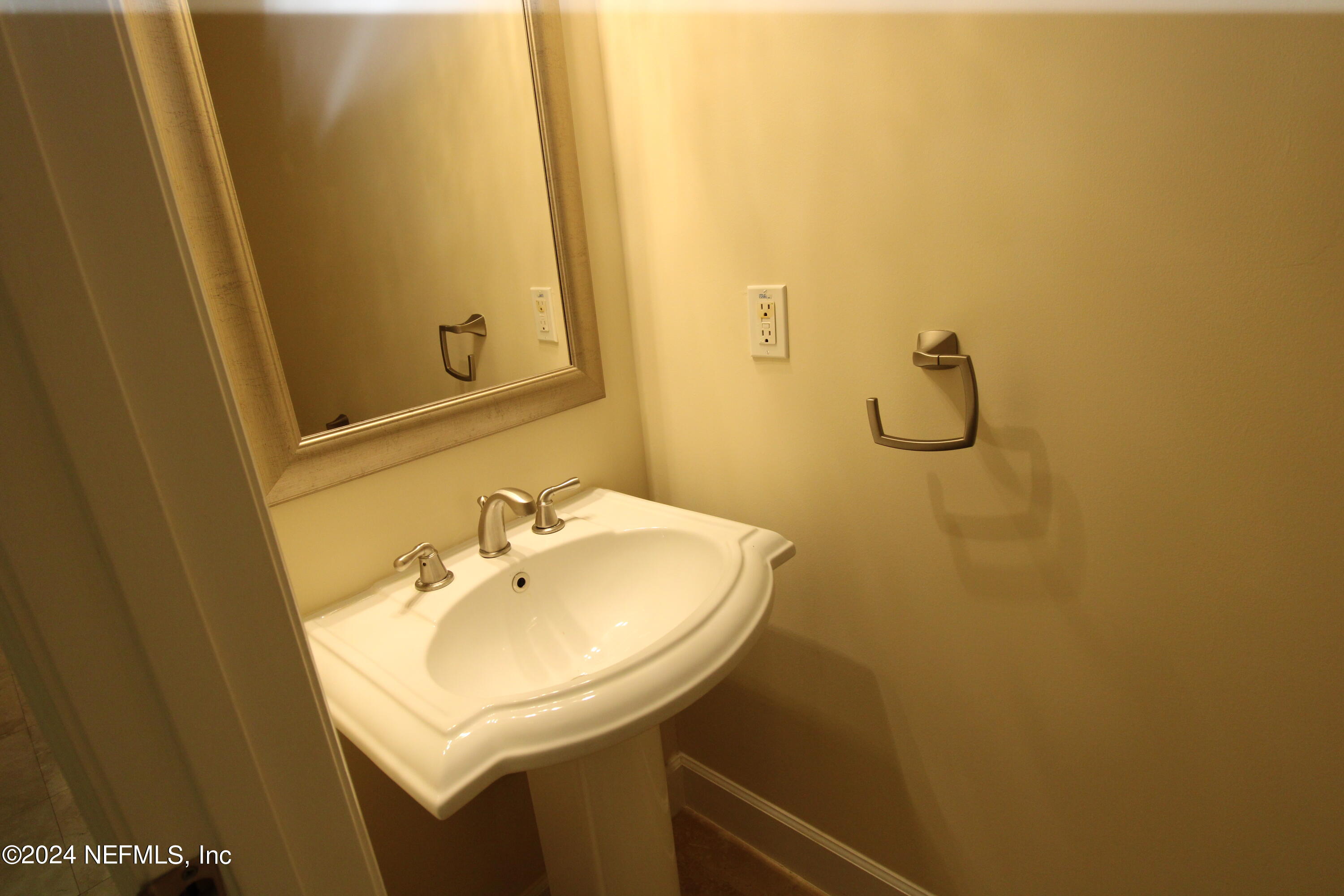 28 Grand Ravine Drive St. Augustine, FL 32086 - Photo 17 of 55 a bathroom with a sink and mirror