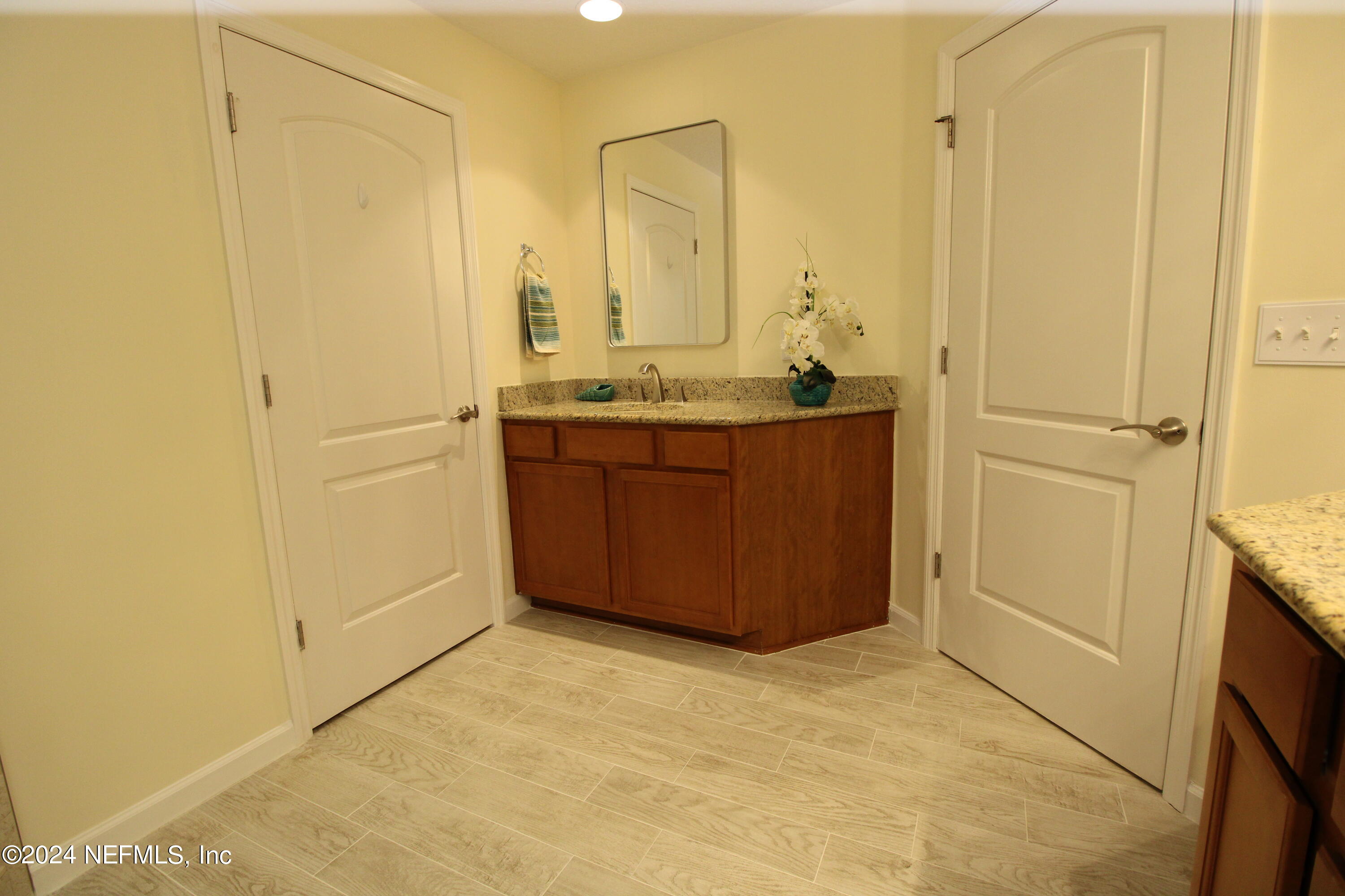 28 Grand Ravine Drive St. Augustine, FL 32086 - Photo 28 of 55 a bathroom with a granite countertop sink and a mirror