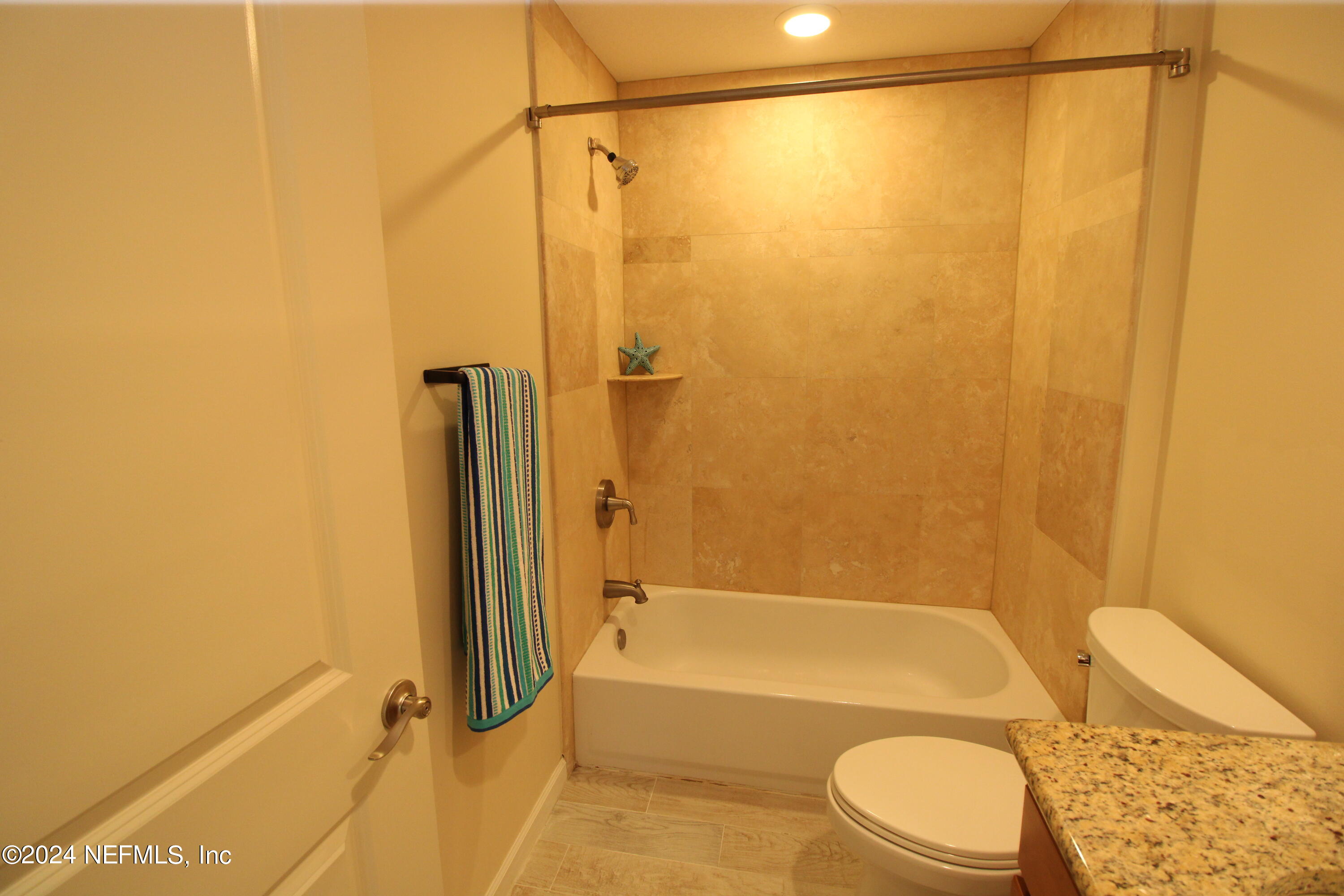 28 Grand Ravine Drive St. Augustine, FL 32086 - Photo 38 of 55 a bathroom with a granite countertop bathtub shower sink vanity and toilet