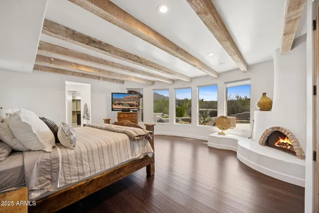 a bedroom with a bed and a flat screen tv