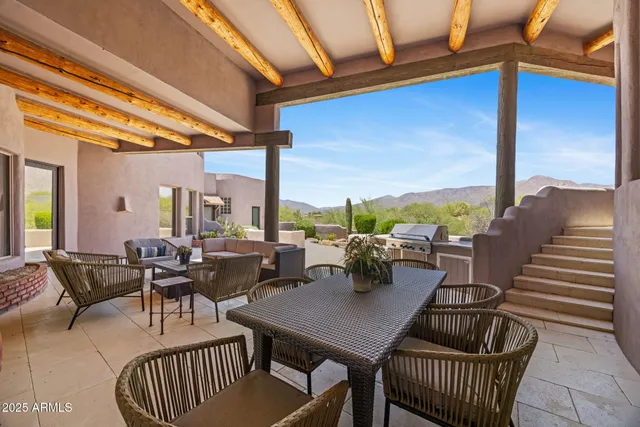 a dining hall with stainless steel appliances granite countertop a sink and a refrigerator