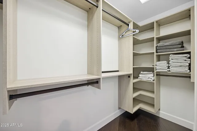 a bathroom with a granite countertop toilet sink and mirror