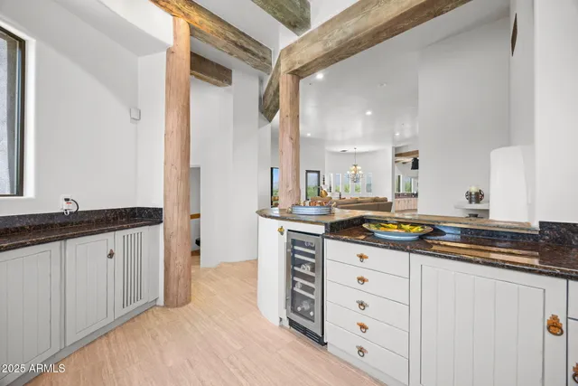 a hallway with cabinets and a fireplace