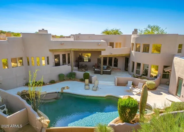 a swimming pool with outdoor seating and yard