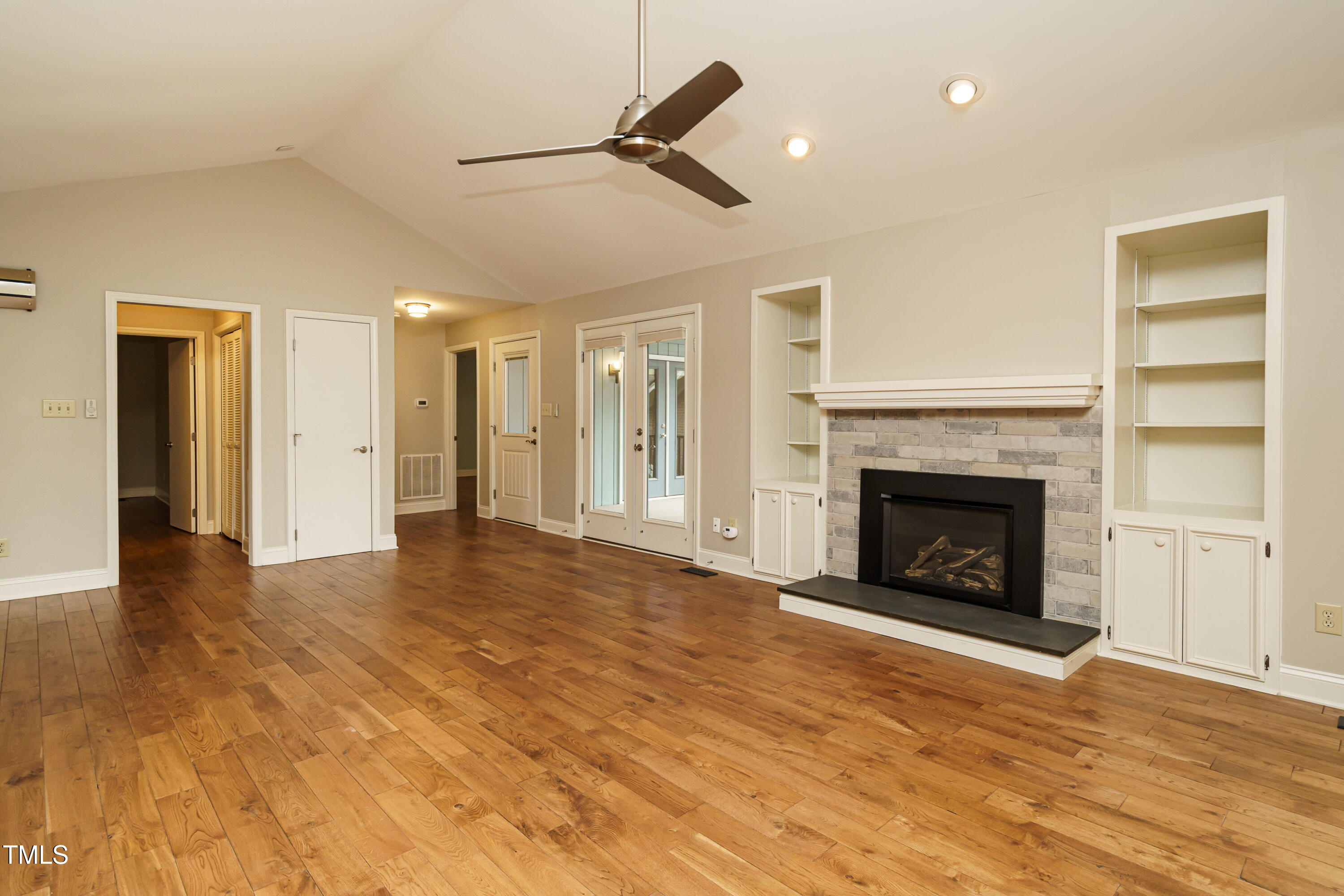 2916 Rue Sans Famille Raleigh, NC 27607 - Photo 14 of 32 a view of an empty room with a fireplace and a window