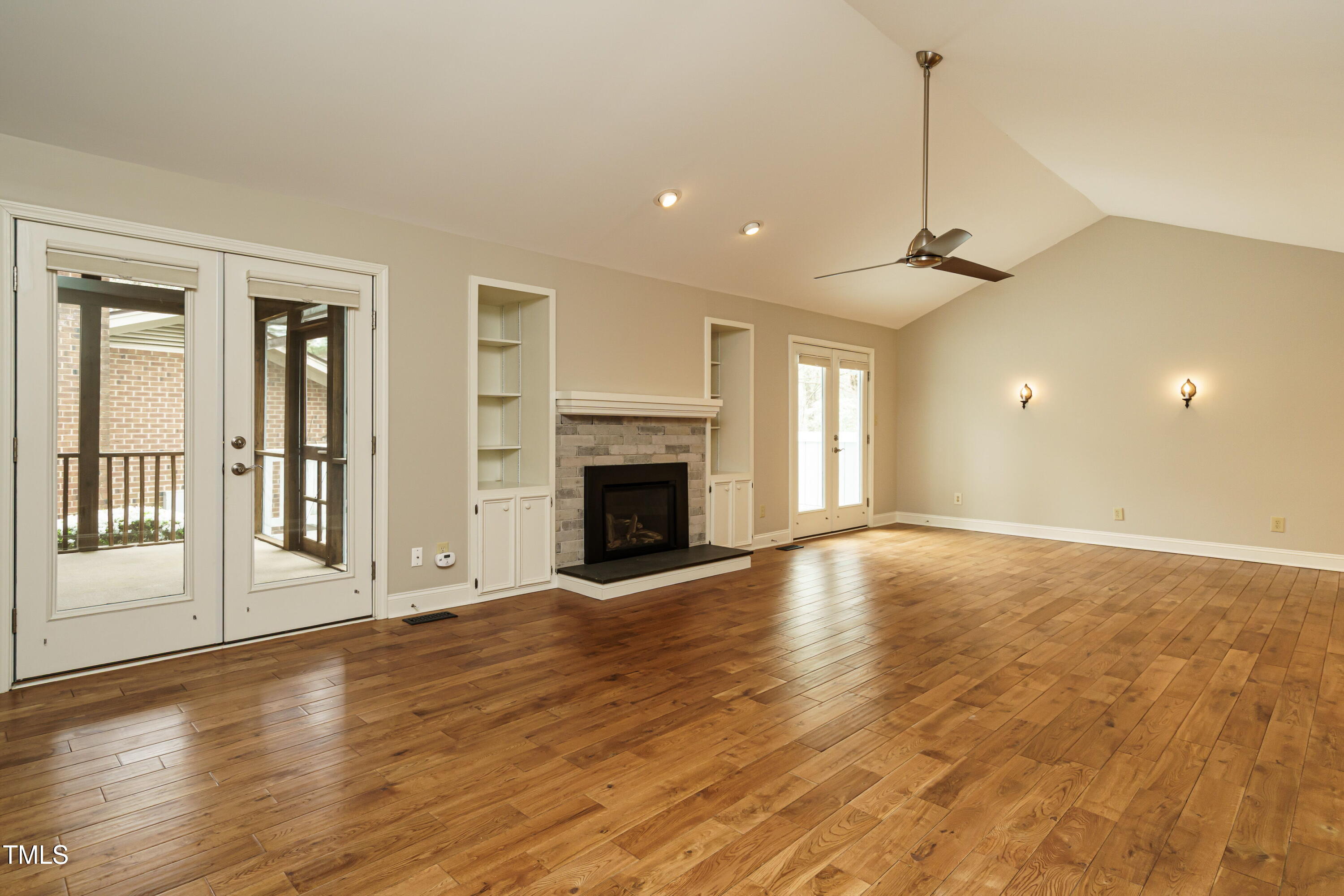2916 Rue Sans Famille Raleigh, NC 27607 - Photo 15 of 32 a view of empty room with wooden floor and fireplace