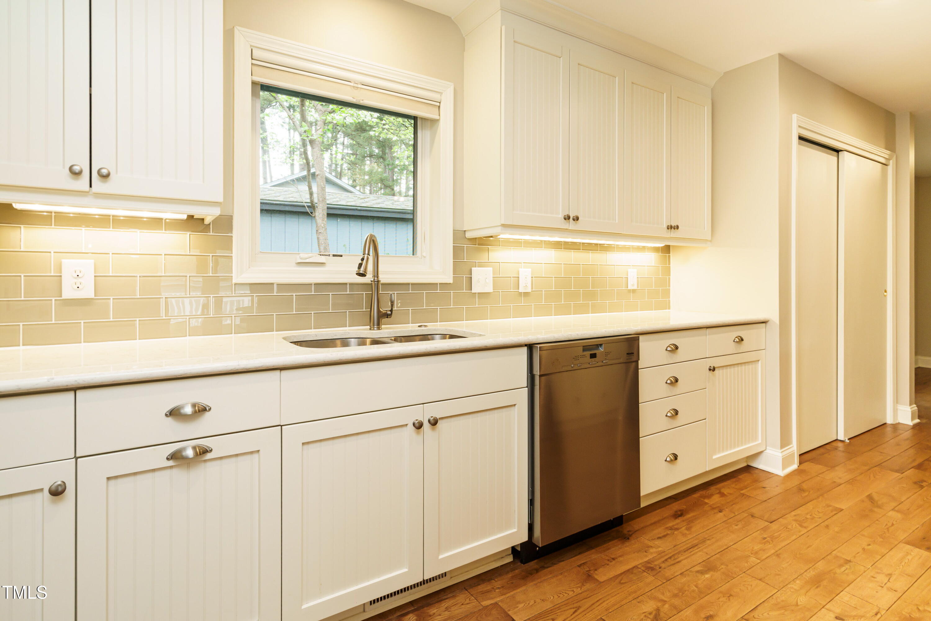 2916 Rue Sans Famille Raleigh, NC 27607 - Photo 18 of 32 a kitchen with white cabinets and window
