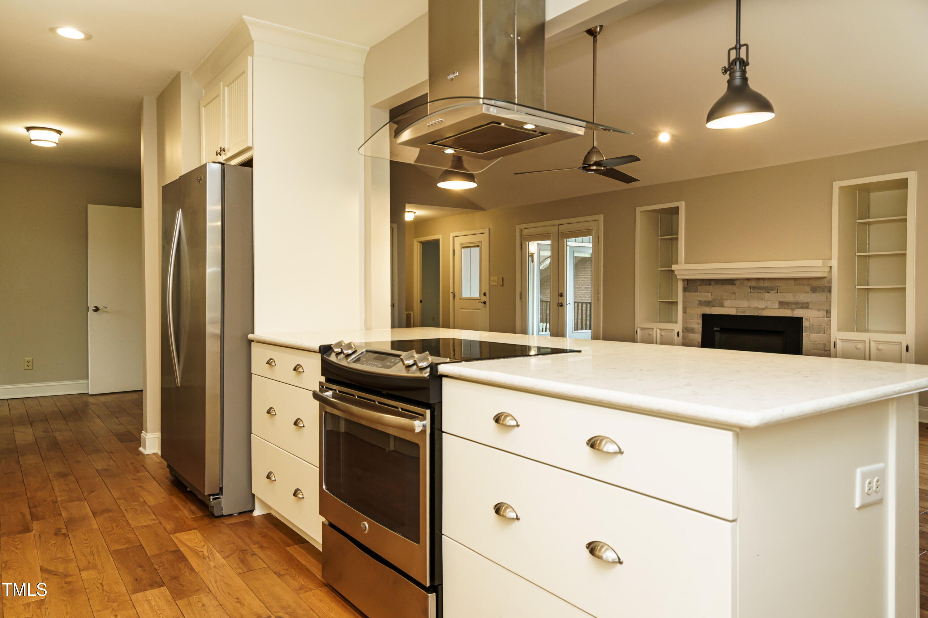 2916 Rue Sans Famille Raleigh, NC 27607 - Photo 20 of 32 a kitchen with a stove a refrigerator and a fireplace