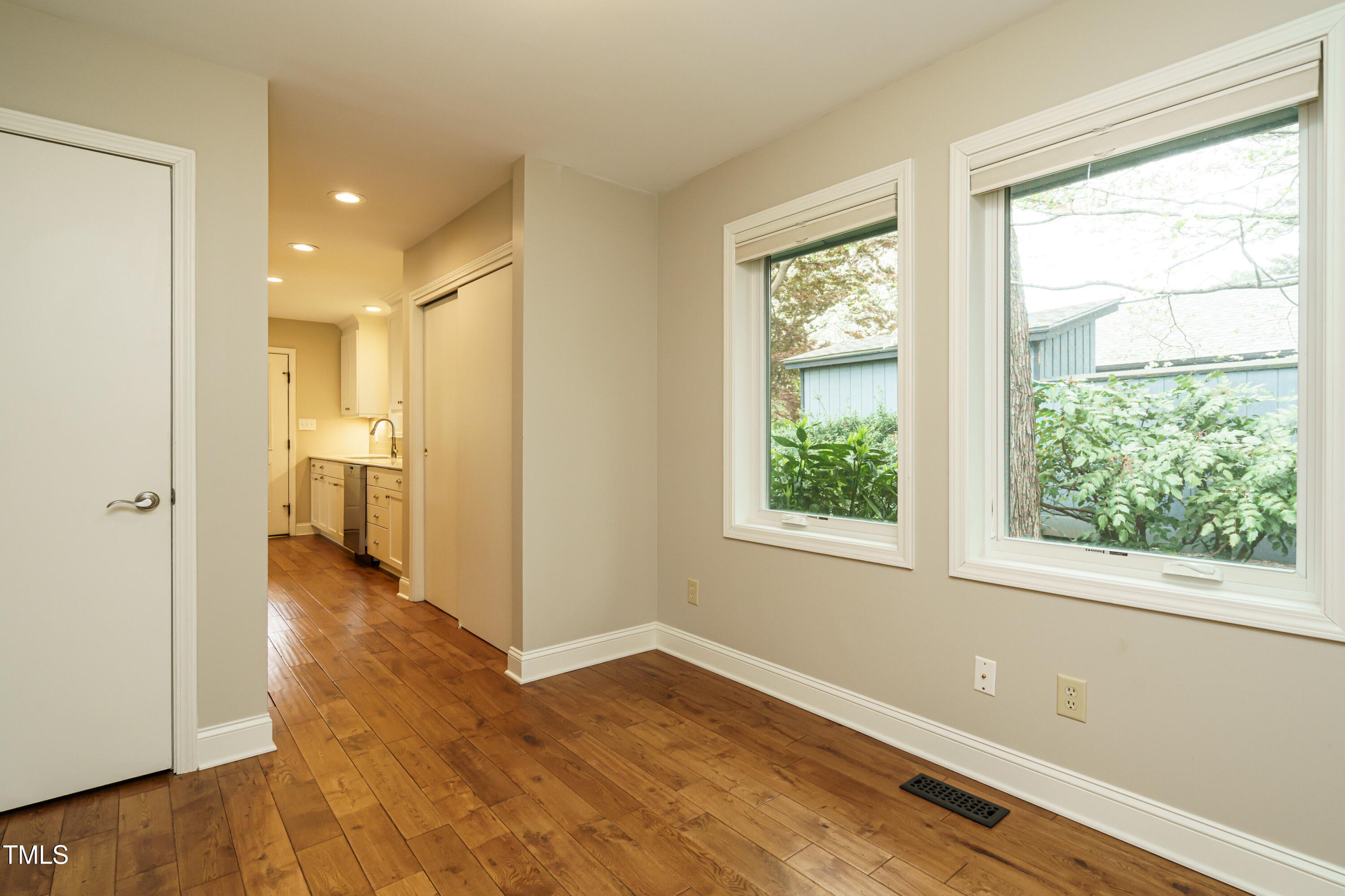 2916 Rue Sans Famille Raleigh, NC 27607 - Photo 21 of 32 a view of a room with wooden floor and a window