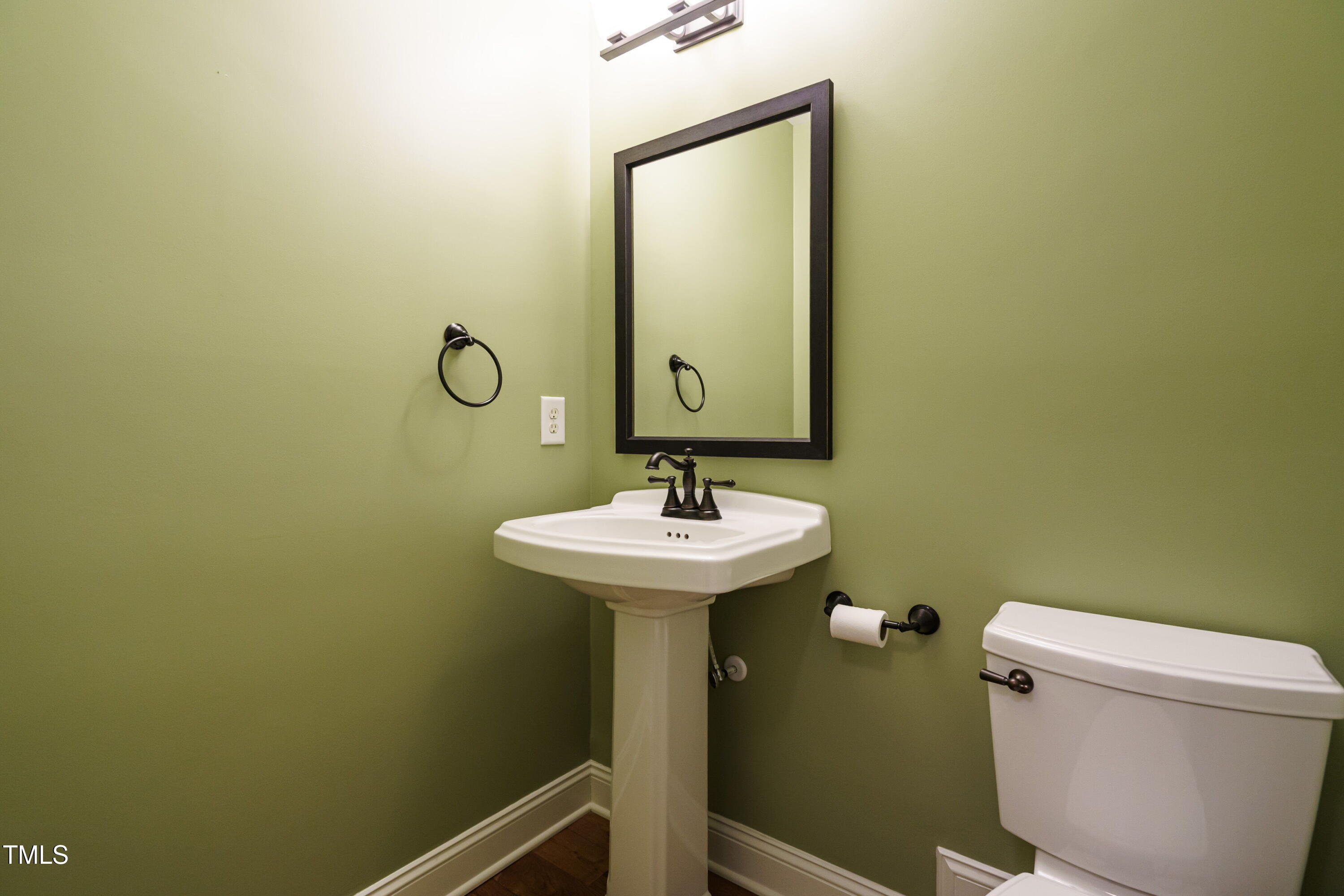 2916 Rue Sans Famille Raleigh, NC 27607 - Photo 25 of 32 a bathroom with a sink a toilet and mirror