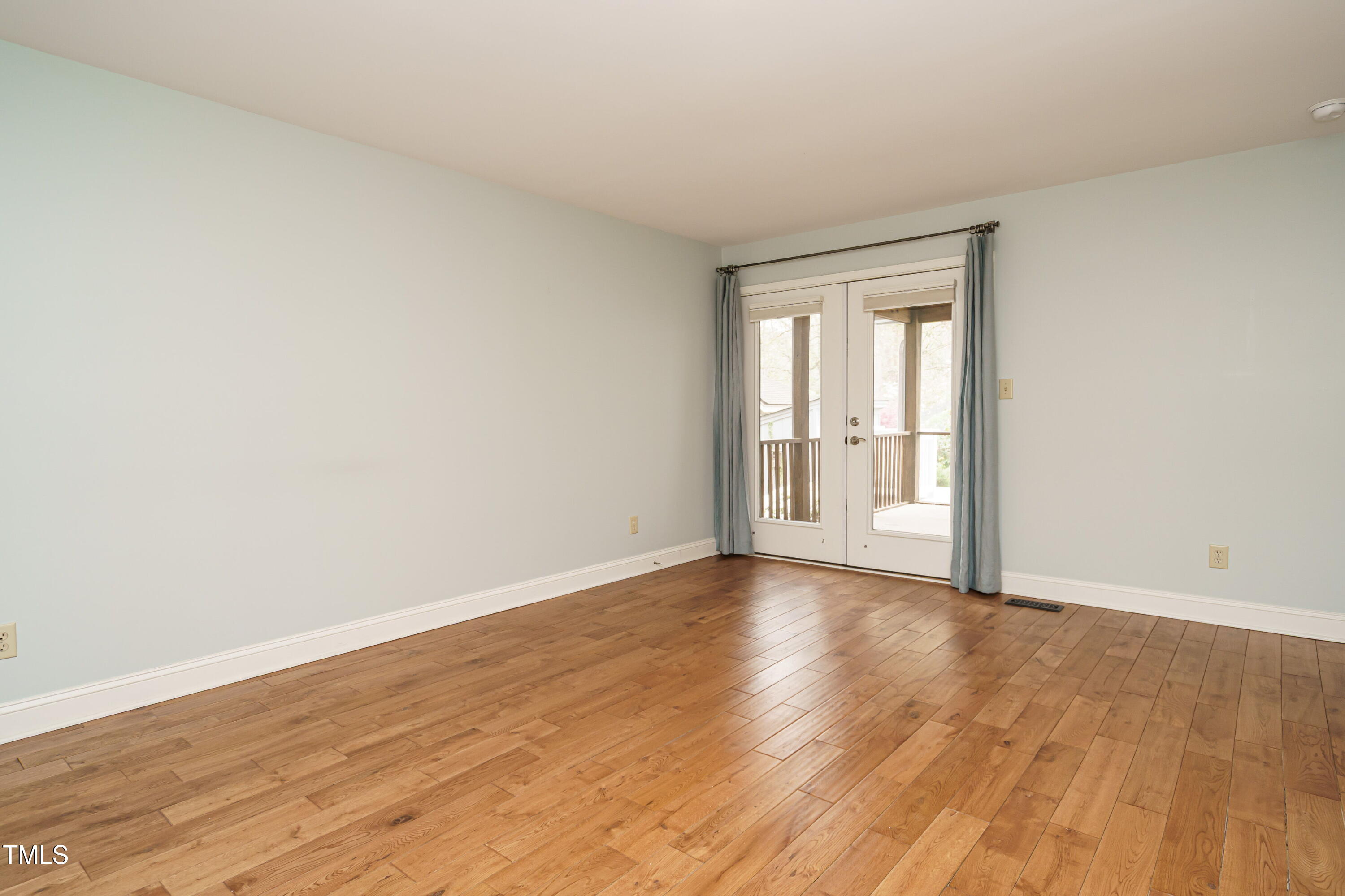 2916 Rue Sans Famille Raleigh, NC 27607 - Photo 27 of 32 a view of an empty room with wooden floor and a window