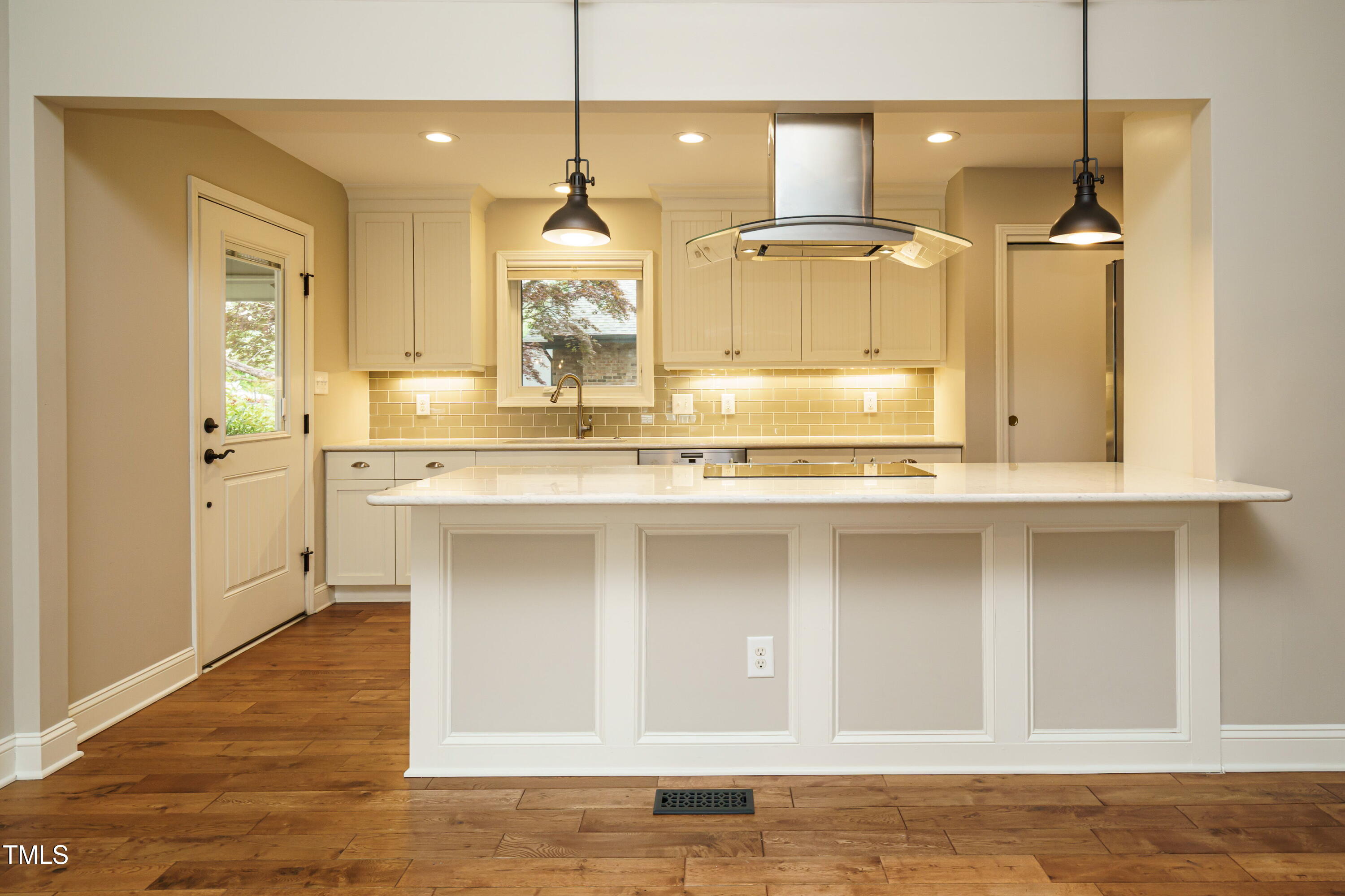 2916 Rue Sans Famille Raleigh, NC 27607 - Photo 3 of 32 a kitchen with stainless steel appliances granite countertop a sink a stove and a wooden floors