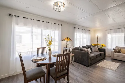 a living room with furniture a table and a large window