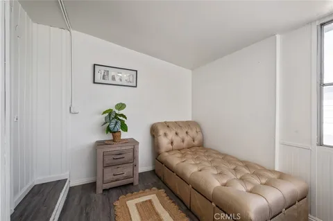 a bedroom with a bed and a potted plant