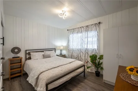 a bedroom with a bed and a potted plant