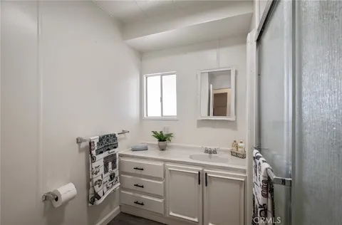 a bathroom with a sink vanity and mirror