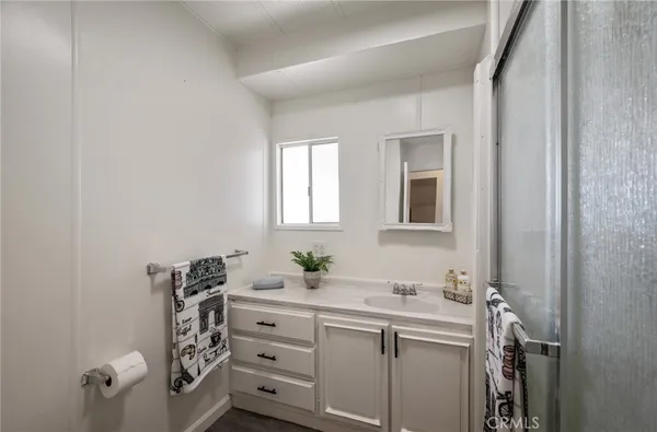 a bathroom with a sink vanity and mirror