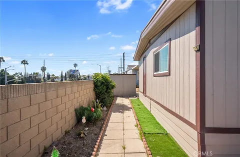 a view of a pathway both side of house