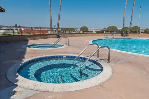 a view of yard with swimming pool and green space