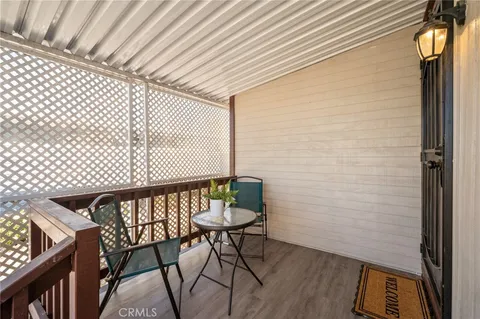 a view of a chairs and table in the balcony
