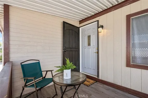 a outdoor room with chairs and wooden floor