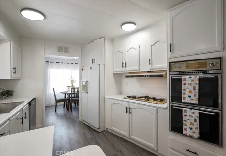 a kitchen with cabinets and appliances