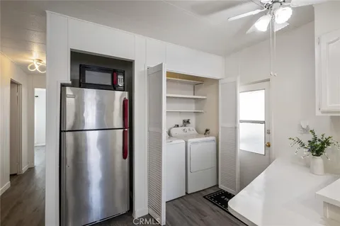 a kitchen with stainless steel appliances a refrigerator and a chandelier