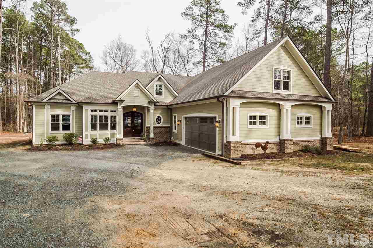 5006 Redwood Road Durham, NC 27704 - Photo 1 of 25 a view of a yard in front of a house with a large tree