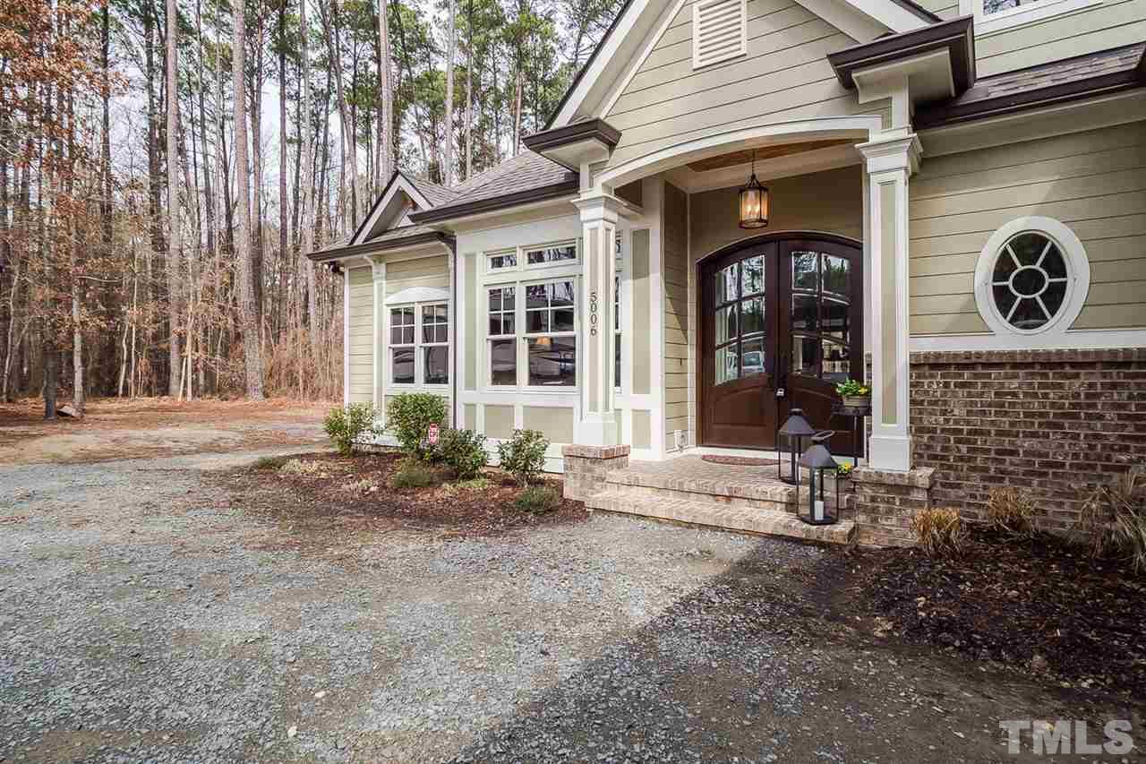 5006 Redwood Road Durham, NC 27704 - Photo 3 of 25 a front view of a house with garden