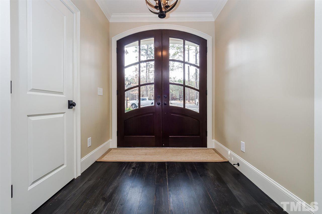 5006 Redwood Road Durham, NC 27704 - Photo 4 of 25 an empty room with wooden floor and windows