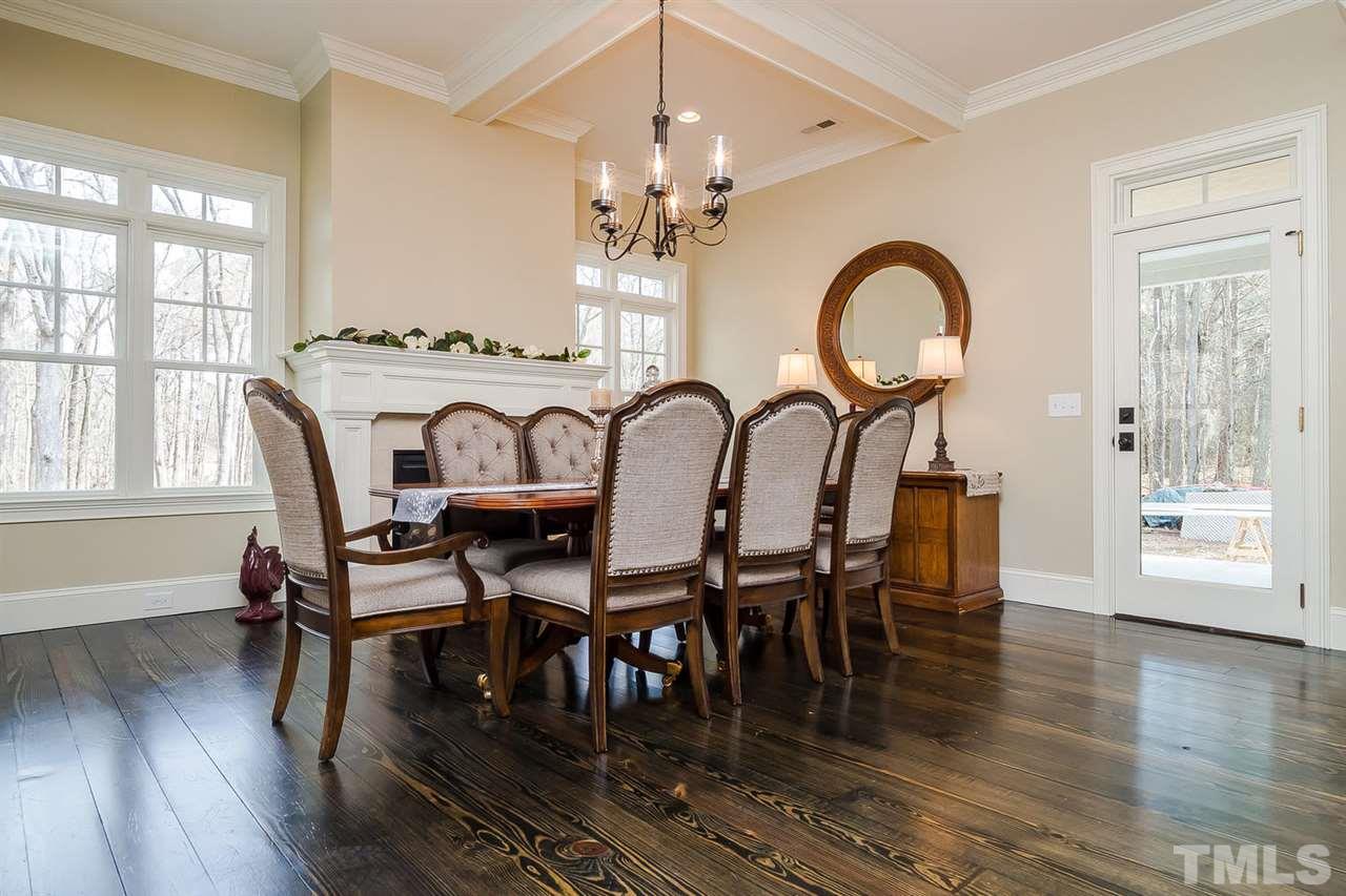 5006 Redwood Road Durham, NC 27704 - Photo 6 of 25 a dining room with furniture a chandelier and wooden floor