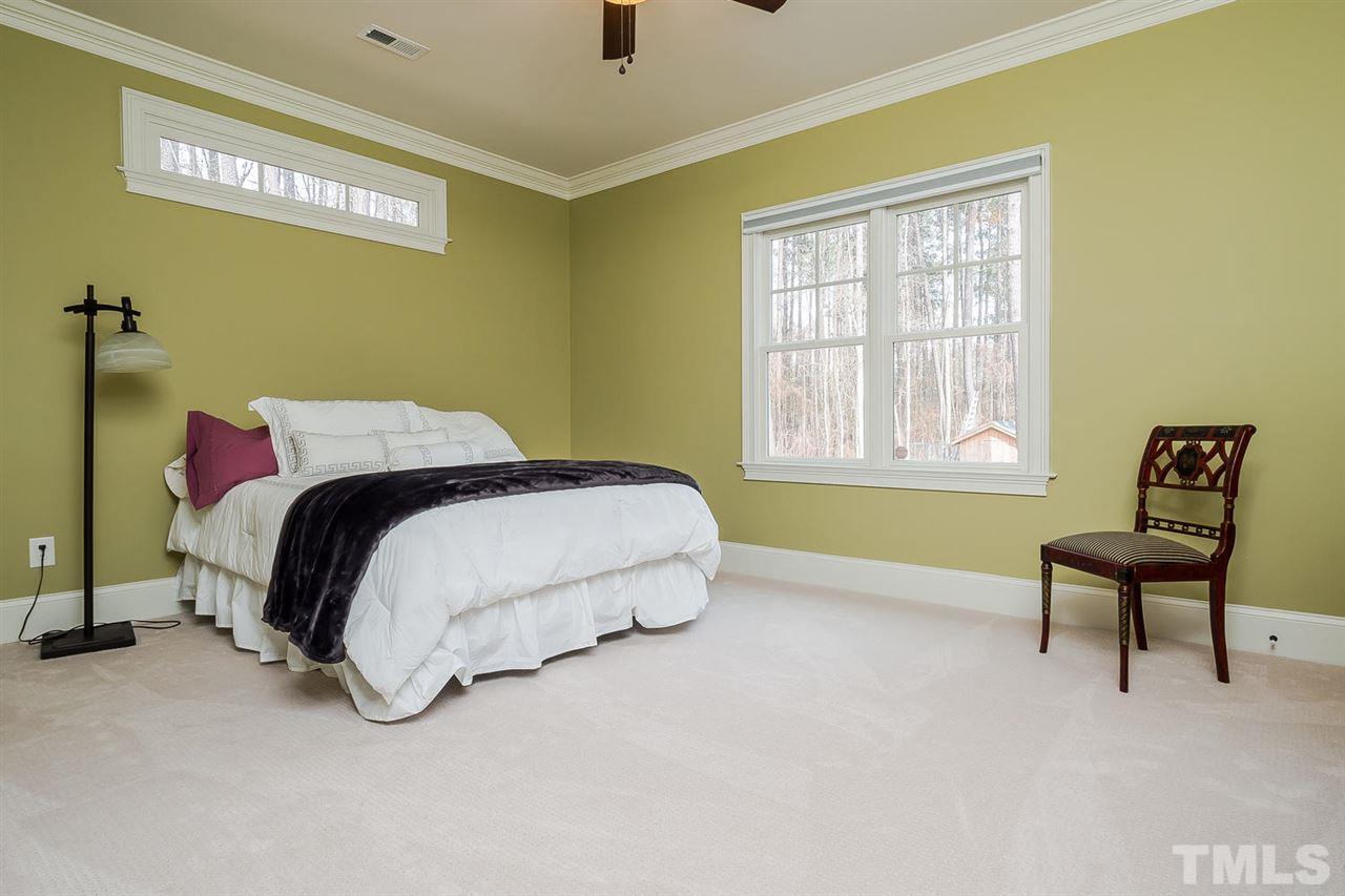 5006 Redwood Road Durham, NC 27704 - Photo 9 of 25 a bedroom with a bed and a chair