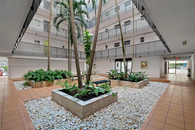 a view of a swimming pool with a patio and garden