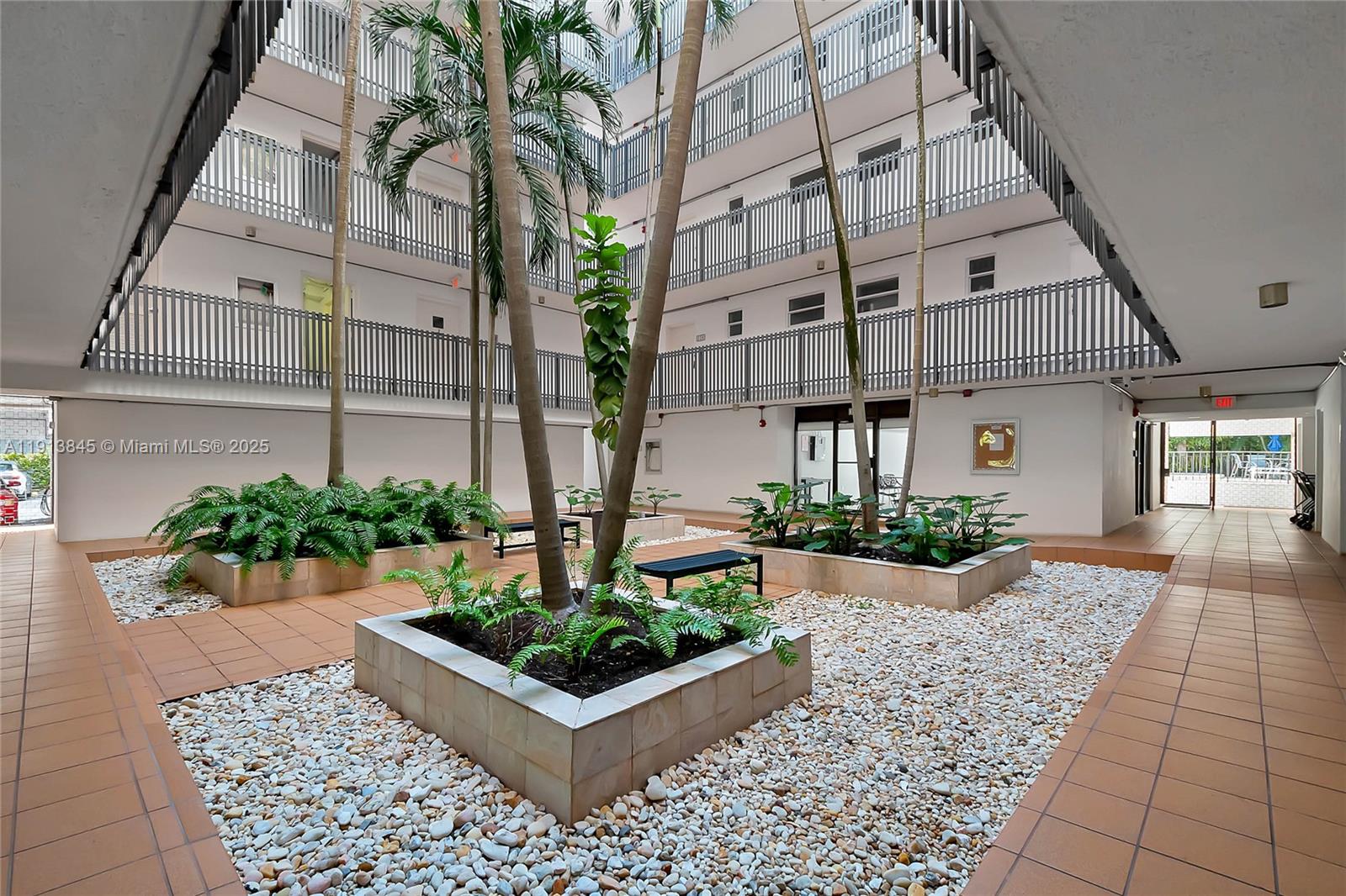 100 Ocean Ln Drive, Unit 202 Key Biscayne, FL 33149 - Photo 16 of 22 a front view of a house with a garden