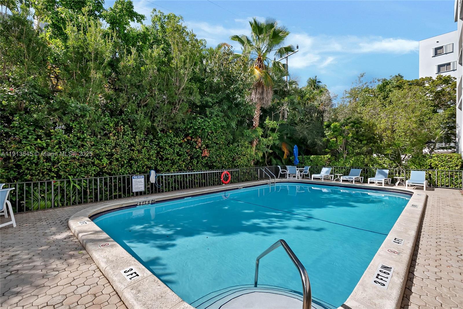 100 Ocean Ln Drive, Unit 202 Key Biscayne, FL 33149 - Photo 17 of 22 a view of a swimming pool with a patio and garden